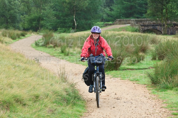 Cyclist on trail just beyond Slippery Stones Bridge, Howden Reservoir, Derbyshire