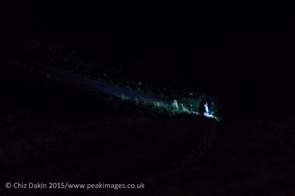 Ghost hunters exploring Dunottar Castle by torch and moonlight.